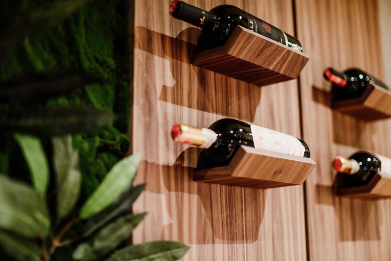 Klajdi Resort Golem  Esterno foto Wine bottles stored on a wall mounted wine rack